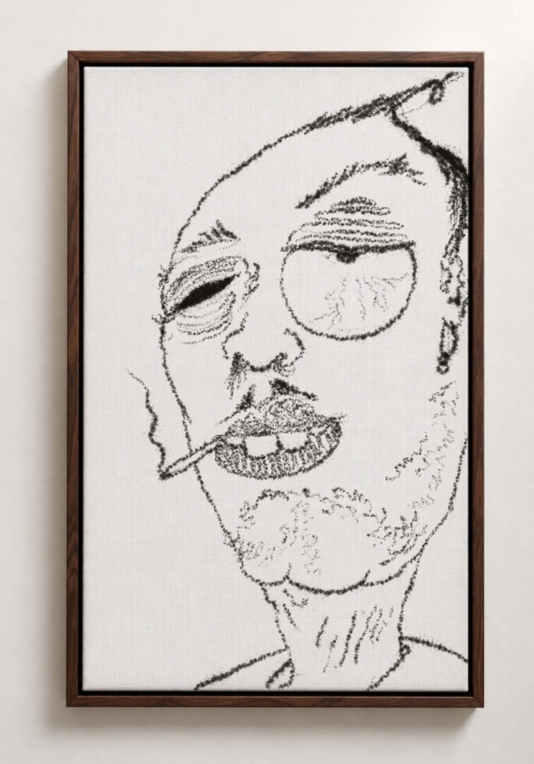 A framed black-and-white caricature of a weary man with round glasses and a cigarette, hanging on a pale wall.