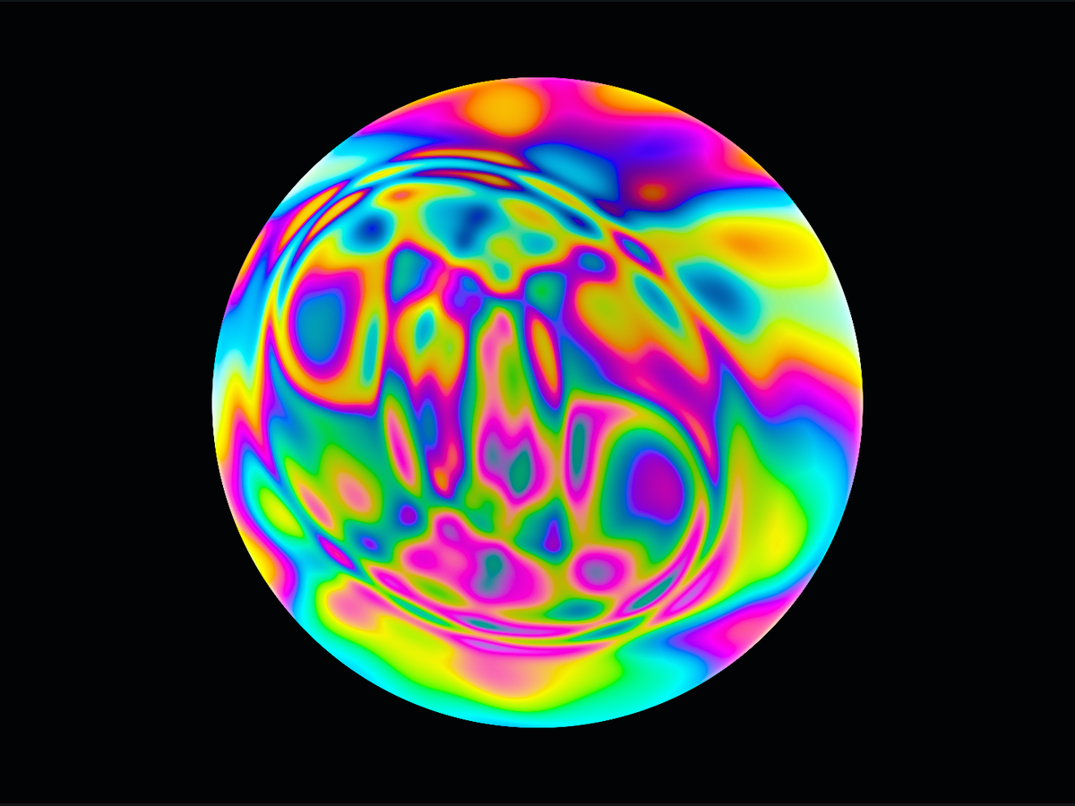Bright bands of reflected colour across a spherical soap bubble against black